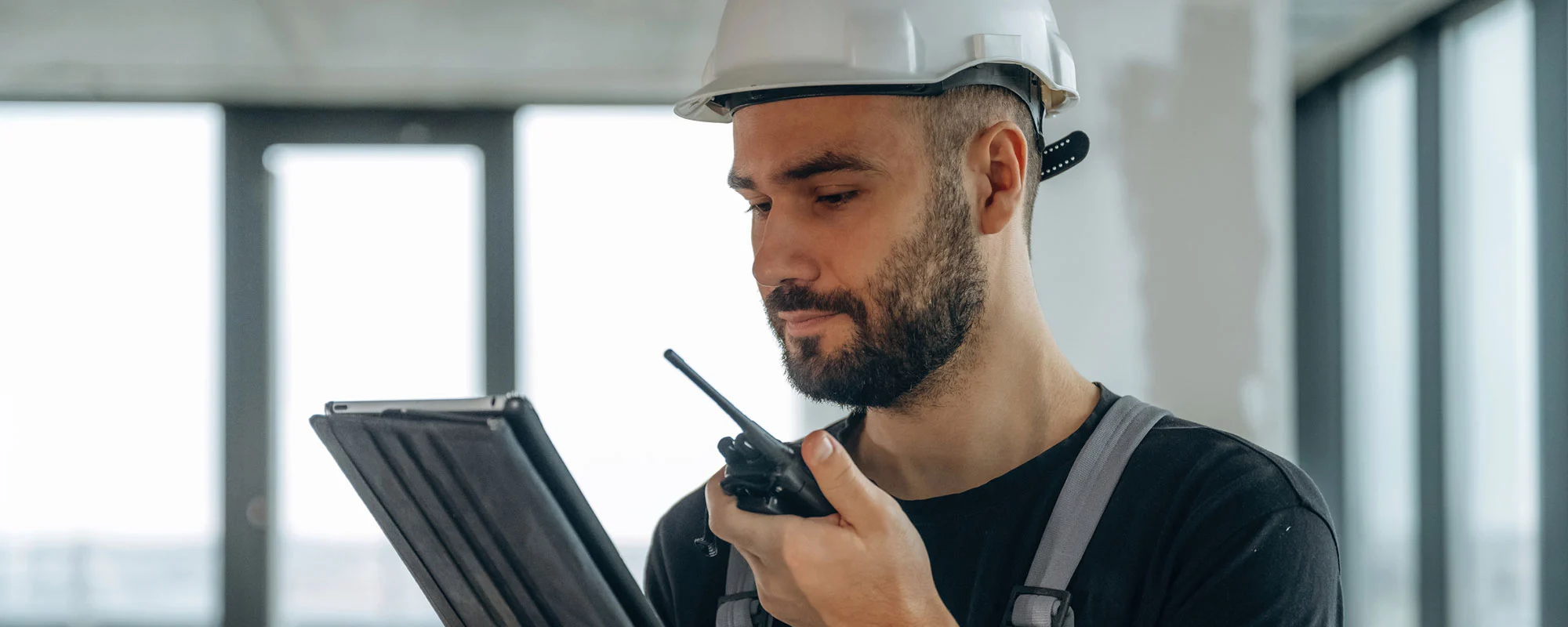 Inspection professional checking equipment with a tablet and radio